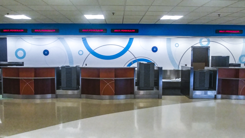 Wall wrap behind the ticket counter at Pensacola International AIrport - Signgeek Environmental Graphics 