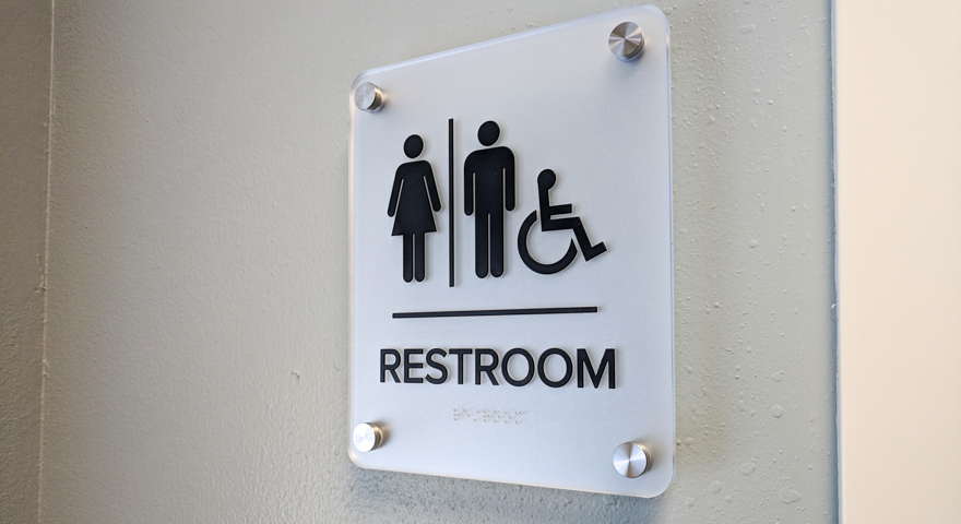 signgeek ADA Wayfinding - ADA compliant restroom signage on aluminum standoffs