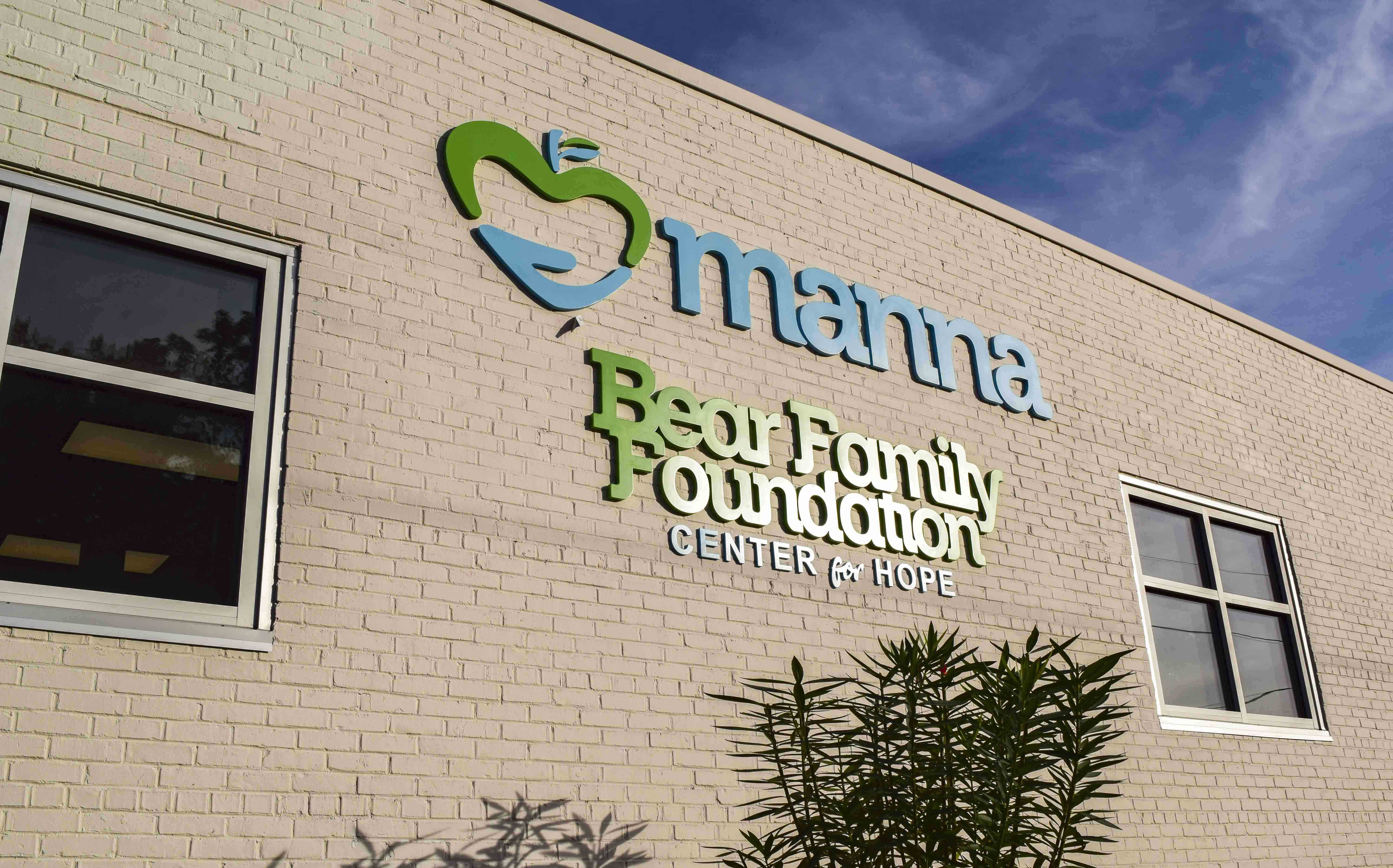 Exterior signage at Manna Food Pantries as part of a branded space - Signgeek Branded Environments