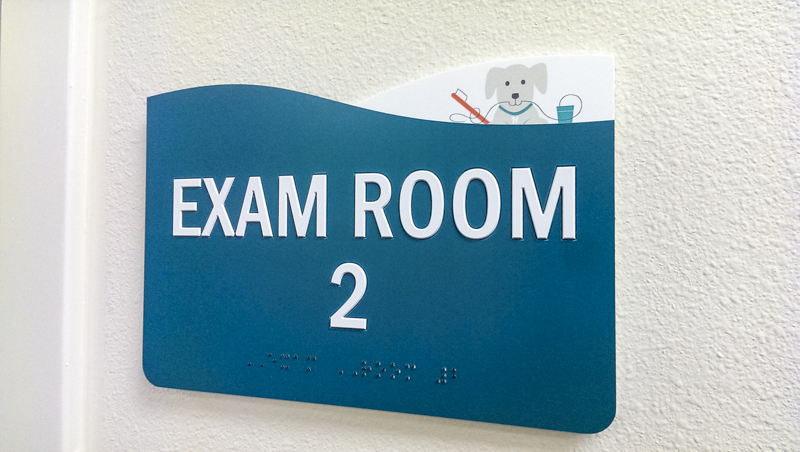 Interior ADA compliant exam room signage for Pensacola Kids Dentistry. Fabricated and installed by Signgeek.
